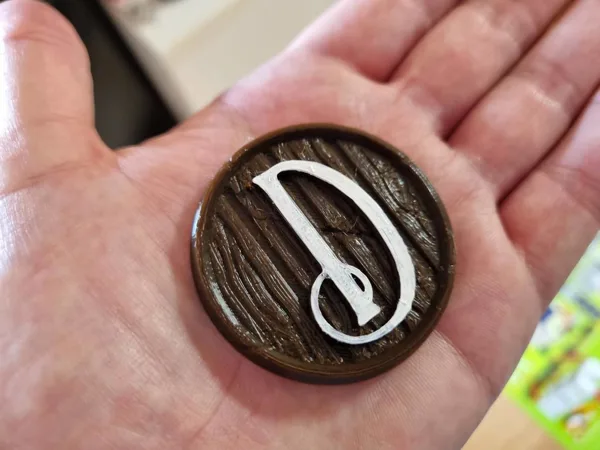 Distilled board game first player token